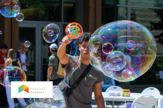 Student using a bubble wand in Seawolf Plaza
