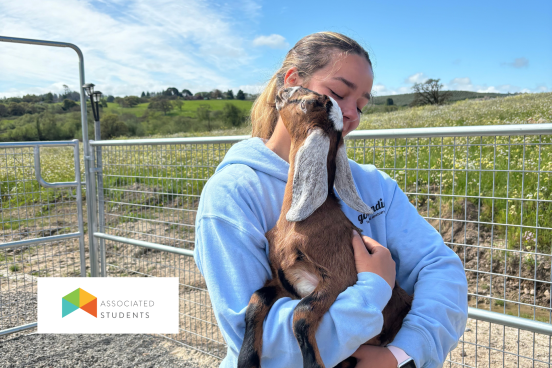 Woman holding a baby goat.