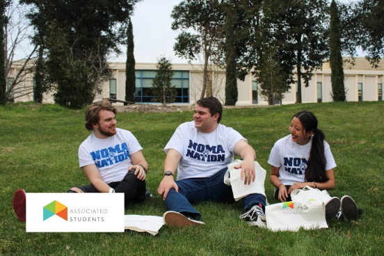 Three students on person lawn talking to each other.