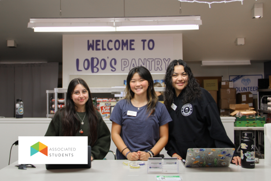Three students working the Lobo's Pantry Check out Counter.