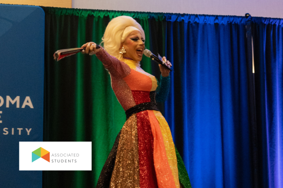 Drag performer holding a microphone.