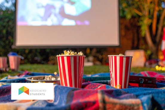 Outdoor projector movie setup and popcorn cups.