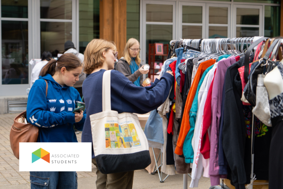 Students picking out clothes from racks in Seawolf Plaza