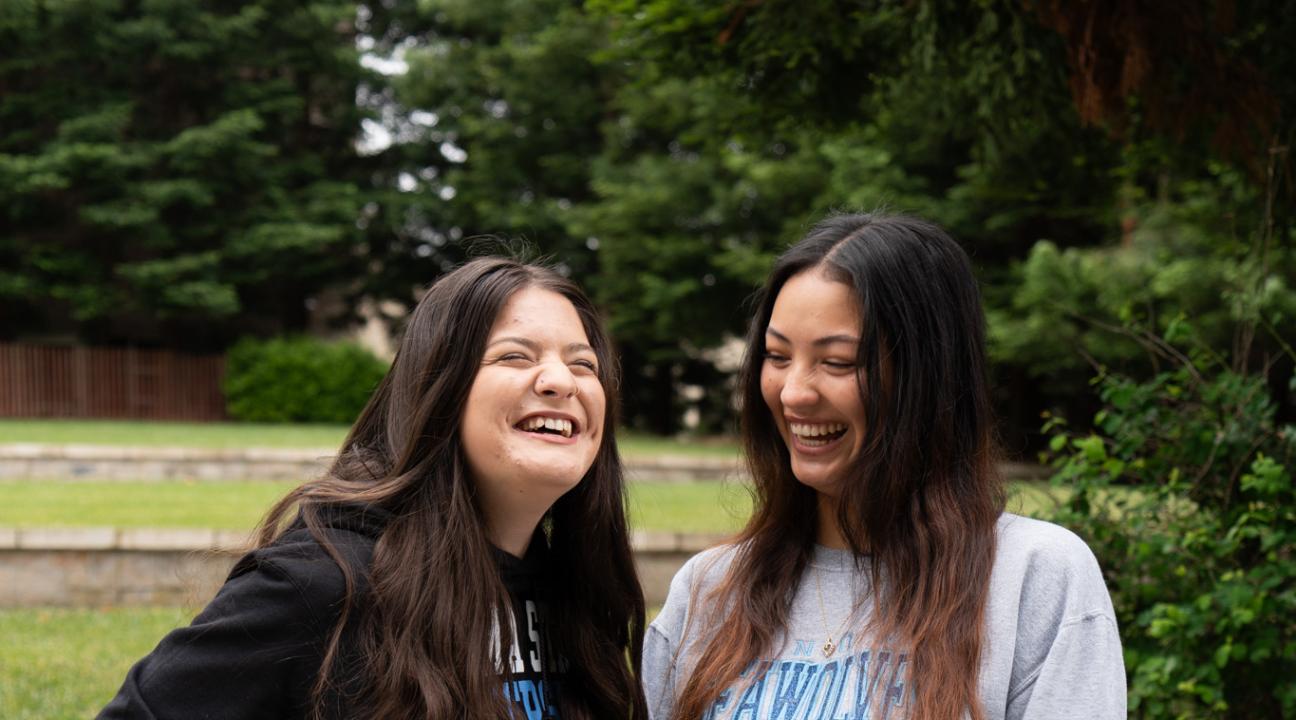 Two student staff laughing together