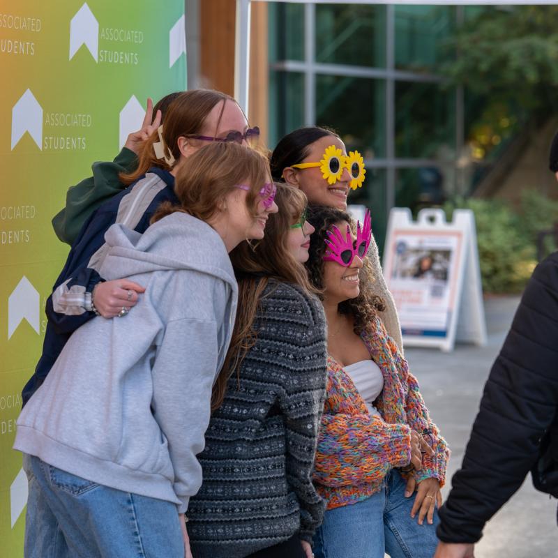 Group of students posing at a photobooth.