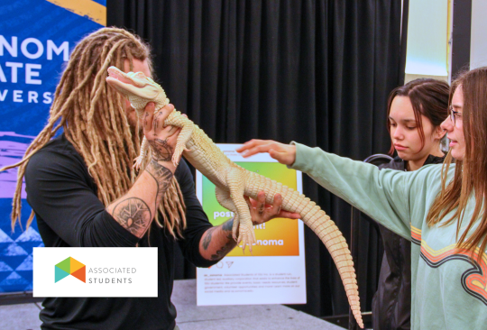 Students petting a baby alligator.