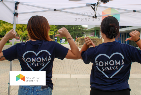 Students pointing to shirts that read "Sonoma Serves"