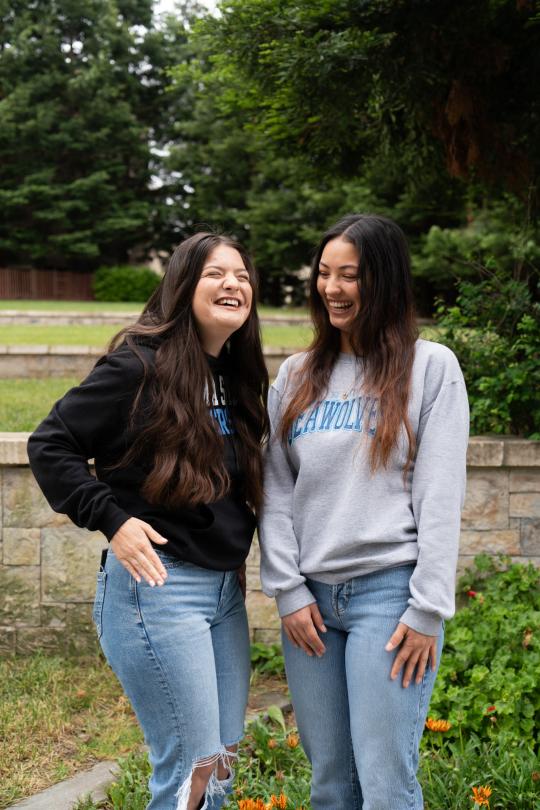 Two student staff laughing together