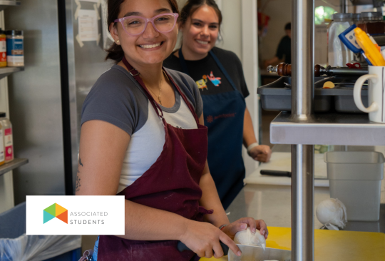 Students chopping onions in a commercial kitchen.