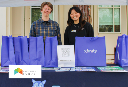 Student Staff at a Lobo's Pantry Table with recipe bag giveaways.