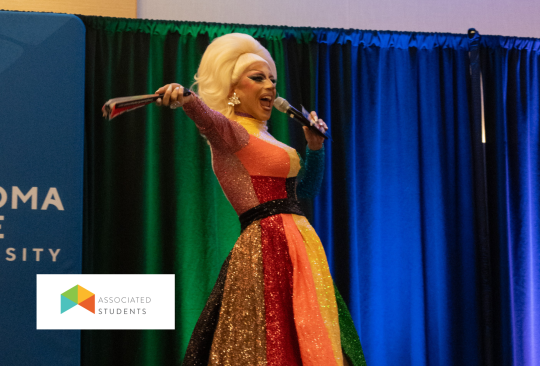 Drag performer holding a microphone.