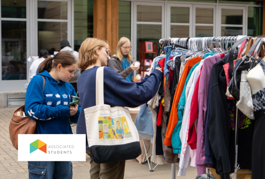 Students picking out clothes from racks in Seawolf Plaza