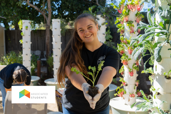 Student holding out a plant