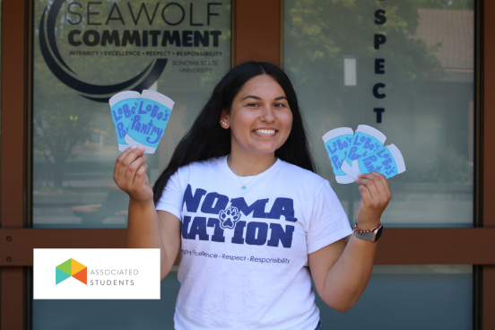Student holding up paper cutouts of canned food.
