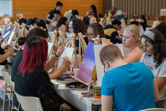 Students painting canvases