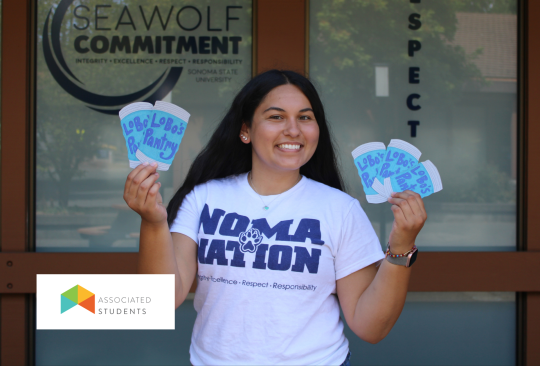 Student holding up paper cutouts of canned food.